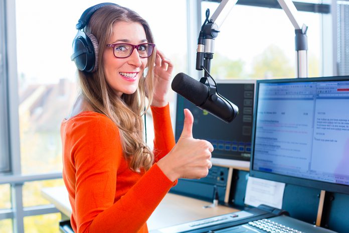 female Presenter in radio station hosting show for radio live in