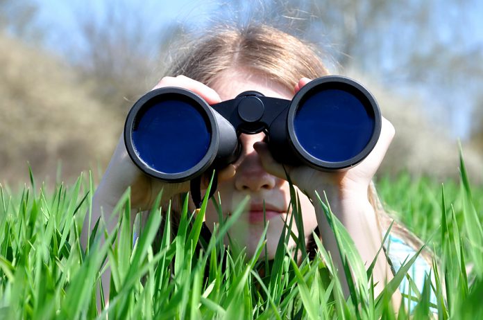 Girl looking through binoculars