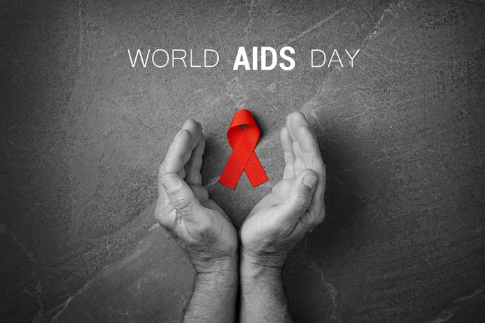 Red Ribbon In Hands On Gray Background, World Cancer Day, Symbol