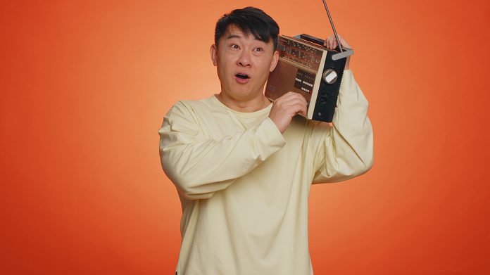 Asian Man Using Retro Tape Record Player To Listen Music, Disco