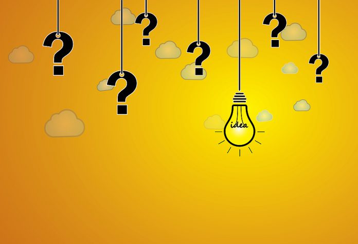 Question Mark & Bright Yellow Light Bulb With Idea Text Hanging