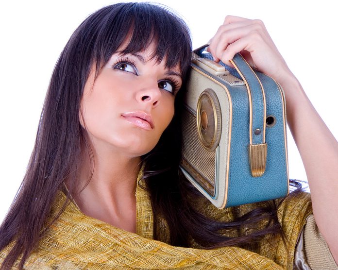 Pretty caucasian woman with handhold radio