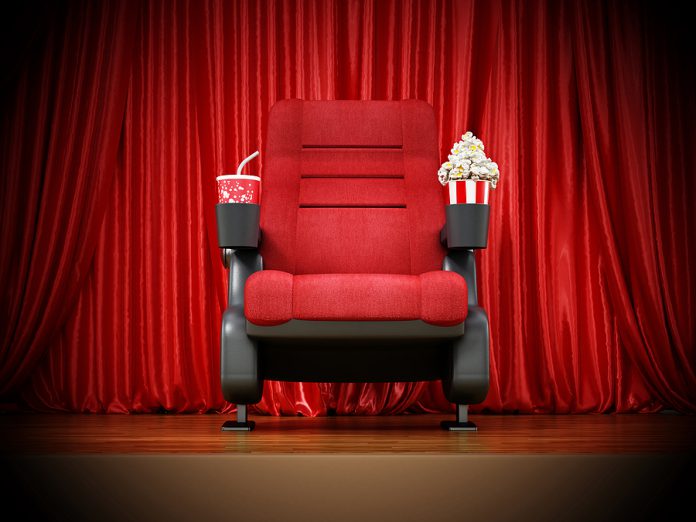 Cinema Chair Standing On Stage In Front Of Thr Curtain. 3d Illus