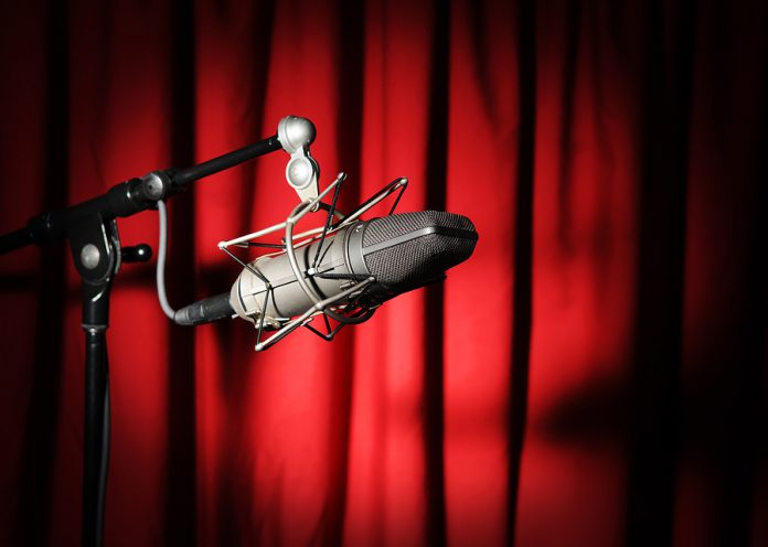 Vintage Microphone Over Red Curtain
