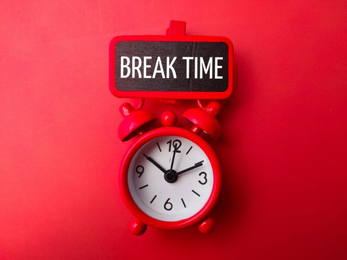Alarm Clock And Wooden Board With The Word Break Time On A Red B
