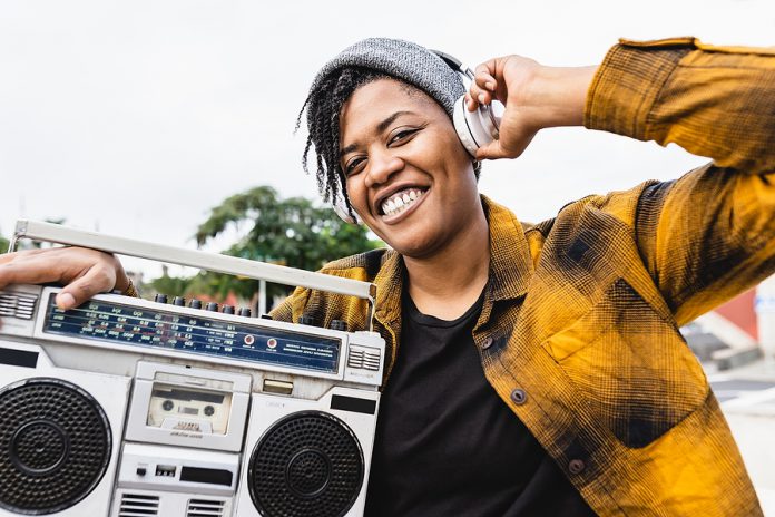 Happy African Girl Having Fun Listening To Music With Headphones