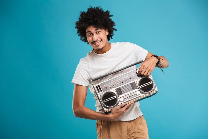 Image of excited young african curly man standing isolated over