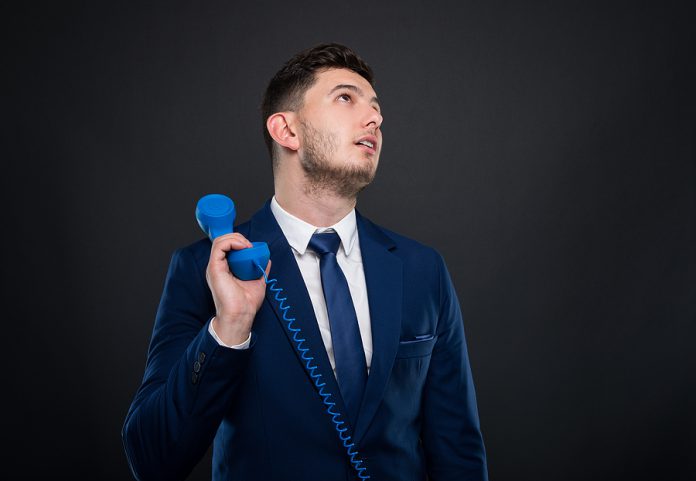 Young Business Man Holding And Talking On Telephone
