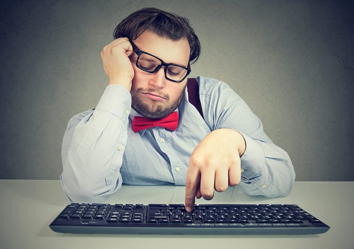 Young Obese Man Sitting At Workplace And Procrastinating Being L