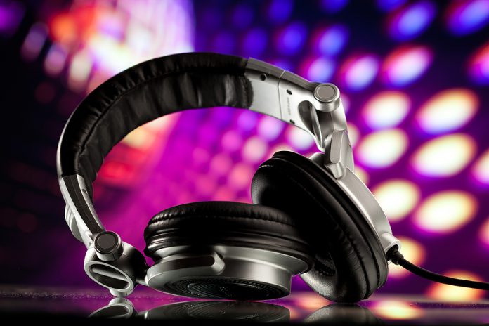headphones against purple disco background