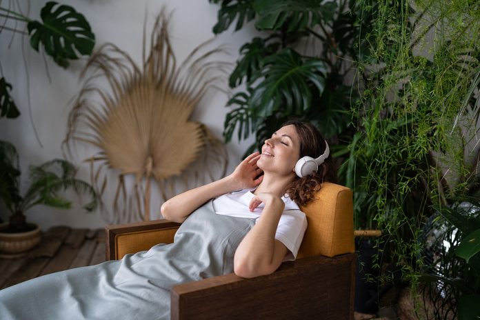 Beautiful Young Pleased Dreamy Female With Closed Eyes Sitting O