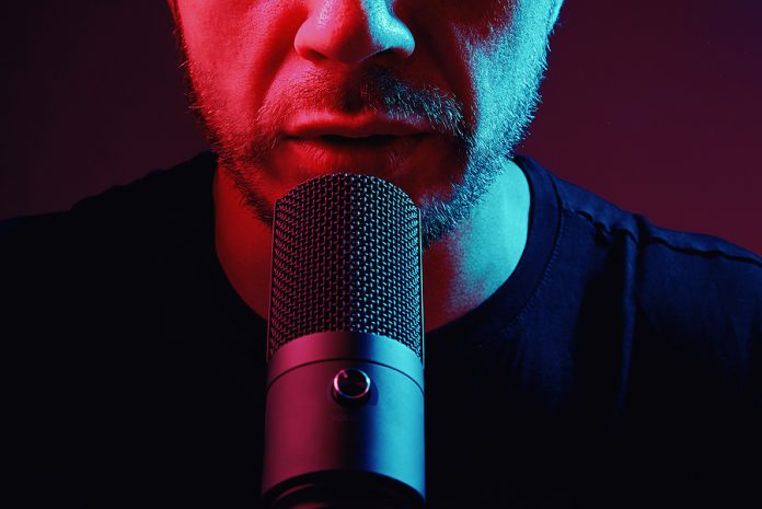 Cropped View Of Man Recording Podcast. Modern Condencer Micropho
