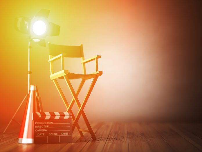 Video, movie, cinema concept. Clapperboard and director chair. F